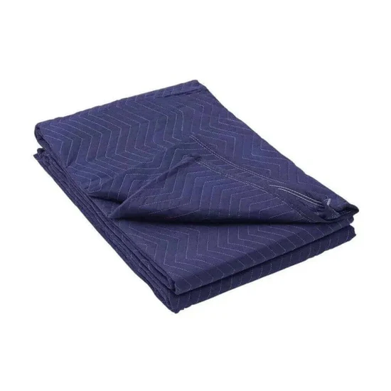 Folded navy blue quilted blanket with a chevron pattern on a white background