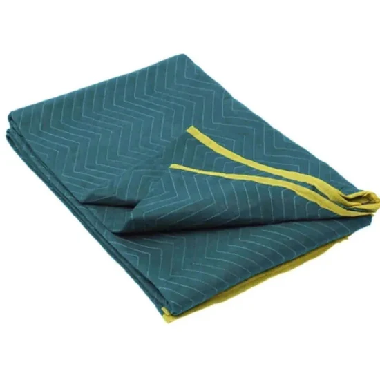 Folded teal blanket with yellow trim and chevron stitching on a white background