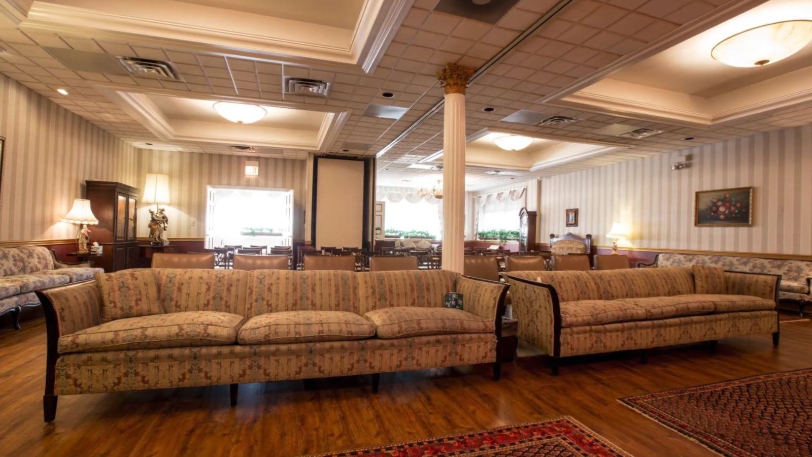 Family lounge at the Caring Cremations funeral home with sofas and lamps