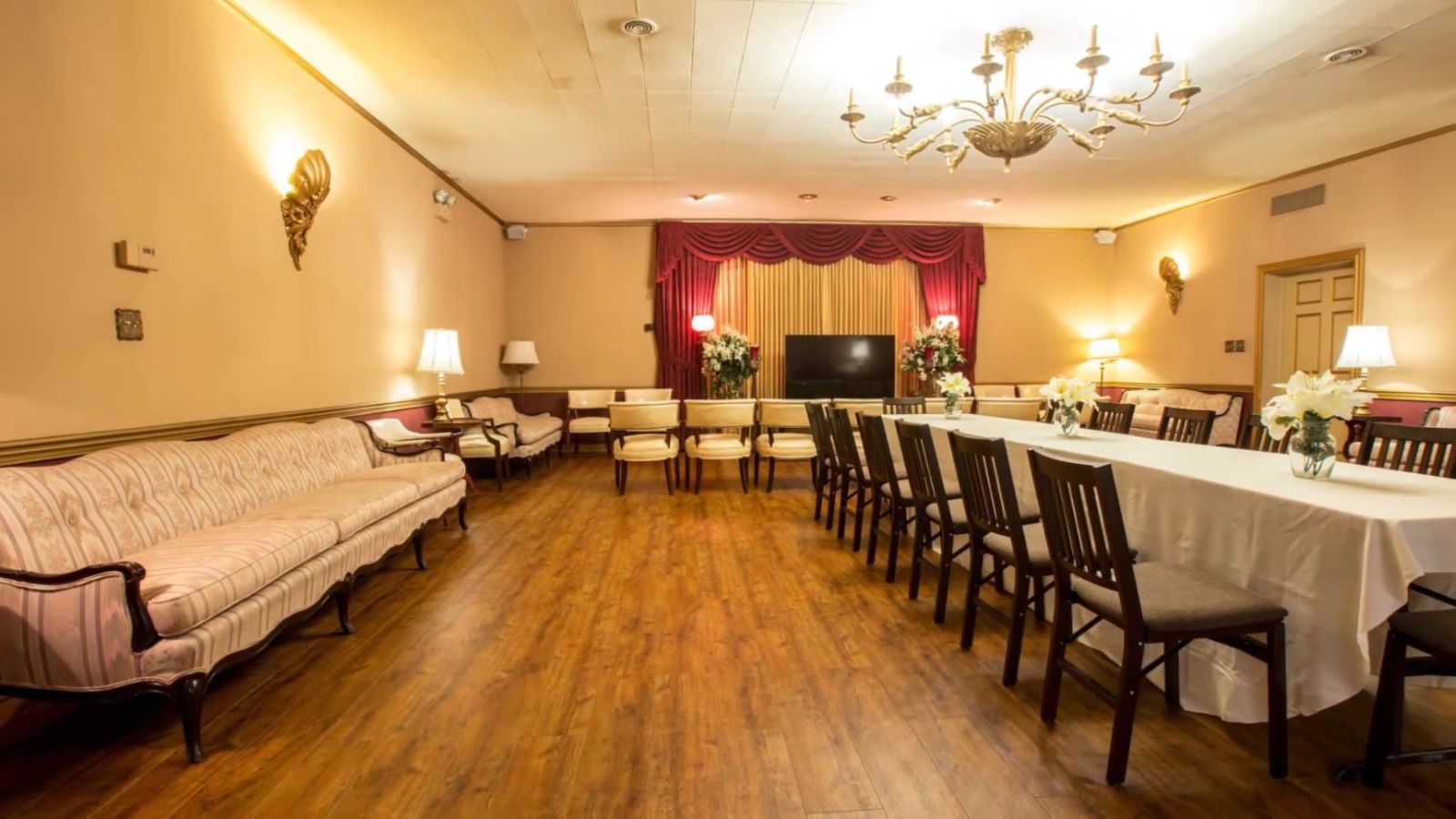 Room at the Caring Cremations funeral home with a long table set with flowers