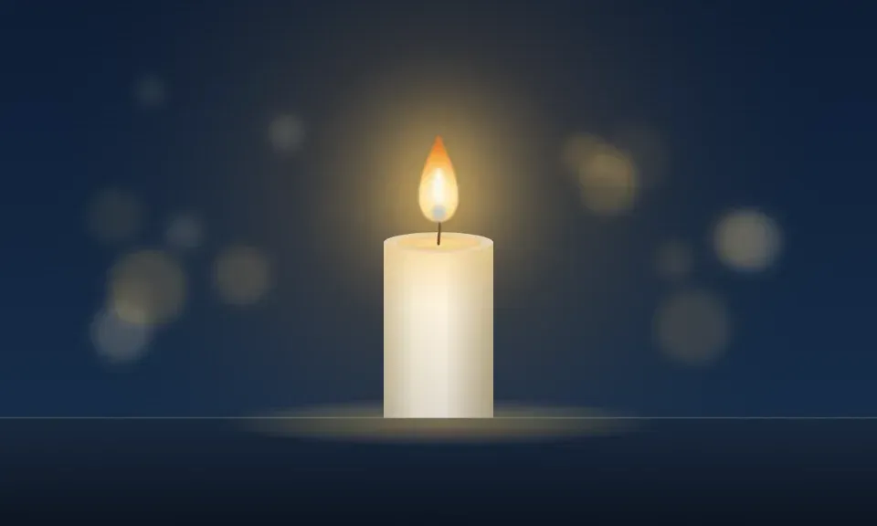 A single lit candle glowing softly in a dark room
