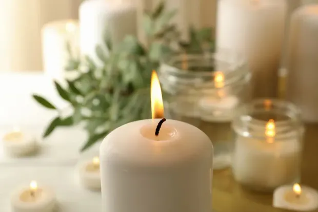 Lit memorial candle representing direct cremation from $997