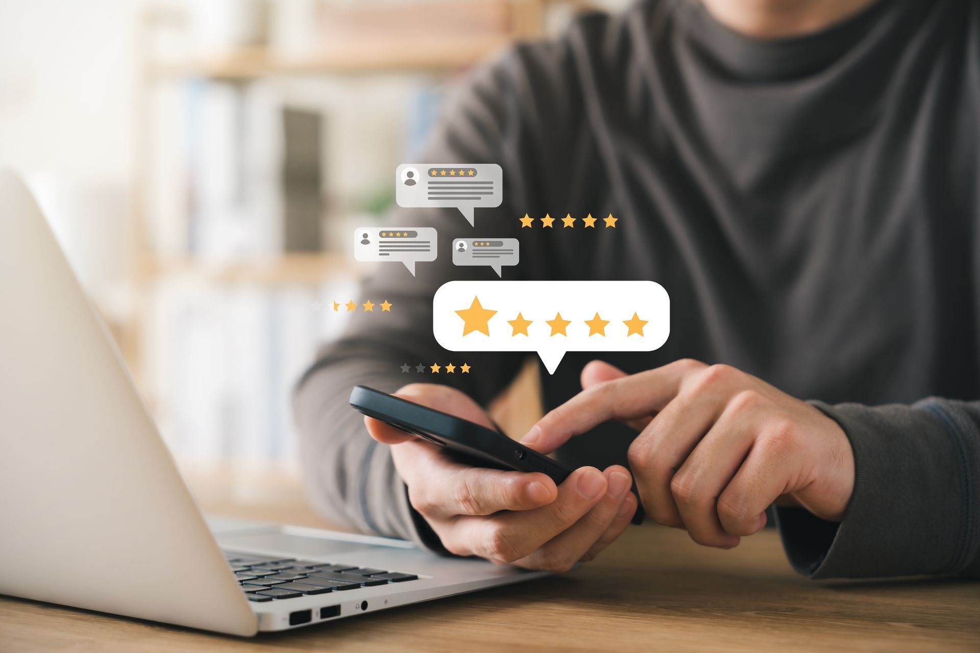Person using a smartphone beside a laptop, with star rating icons floating above.