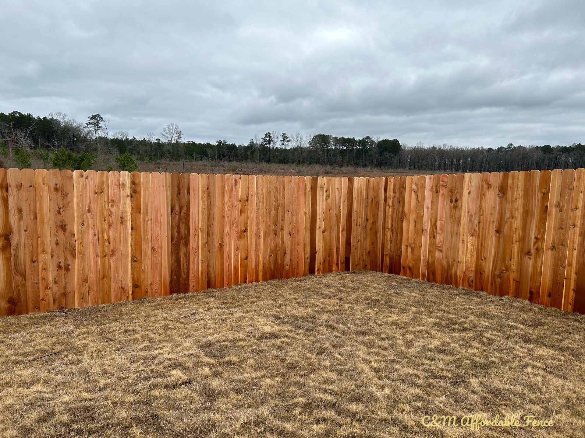 There is a wooden fence in the middle of a field.