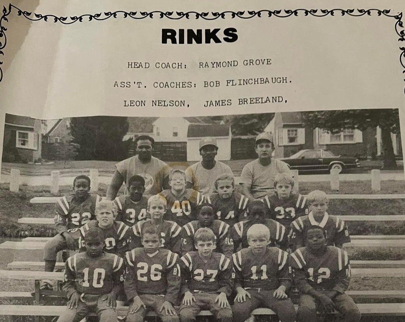 Vintage team photo of football players in jerseys seated on bleachers with a title reading “RINKS” above them