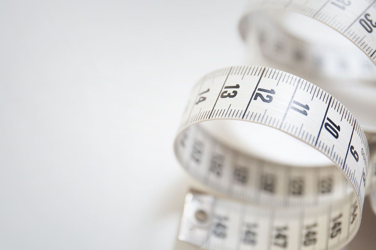 a close-up of a measuring tape on a white surface