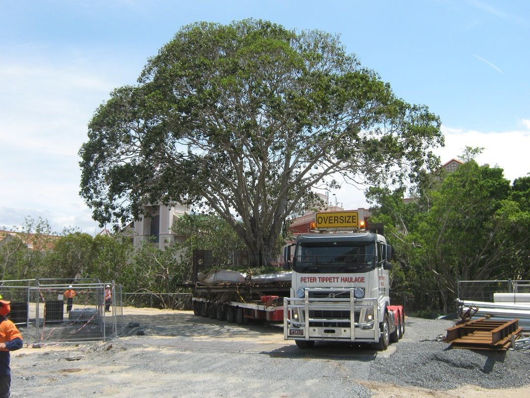 A large white truck with a yellow sign on top that says kapro