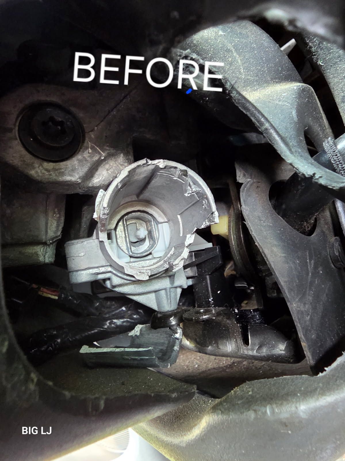 Before photo of a car headlight bulb socket inside a vehicle housing