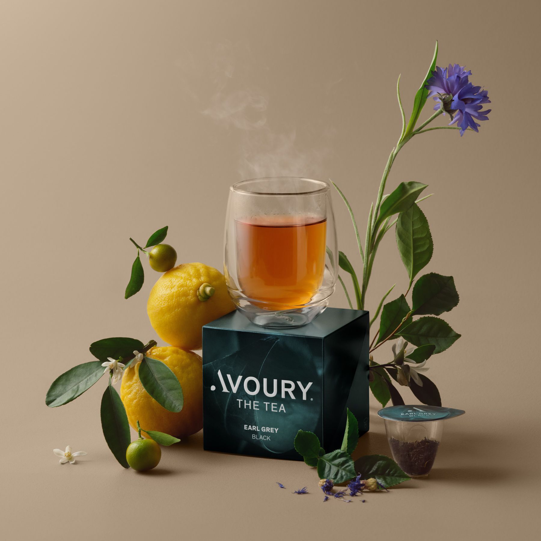 A glass of tea steams on a box labeled