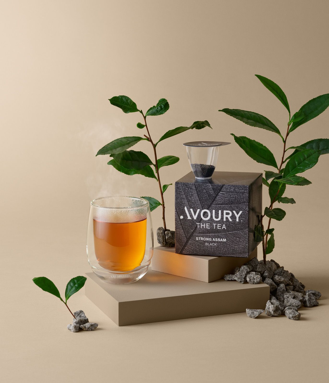 Amber drink and IVORY bottle on a beige pedestal with green leaves and pebbles.