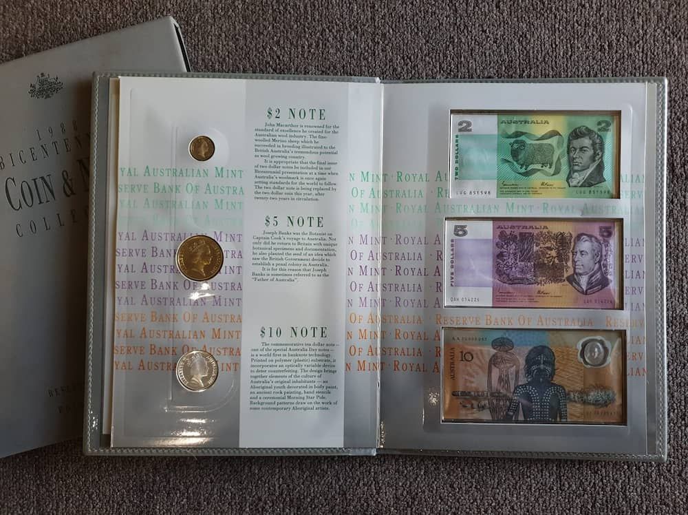 A Collection Of Coins And Bills Is Opened To A Page That Says 12 Note — John Platts Stamps & Coins In Mackay, QLD