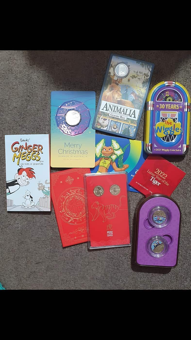 A Bunch of Books and Toys Are Sitting on a Table — John Platts Stamps & Coins In Cairns, QLD