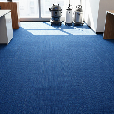 Blue carpeted office corner with two vacuum cleaners near bright windows