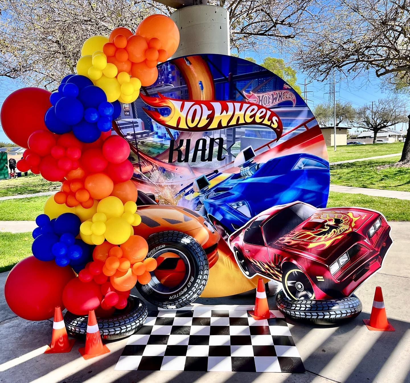 a hot wheels birthday party with balloons and a car