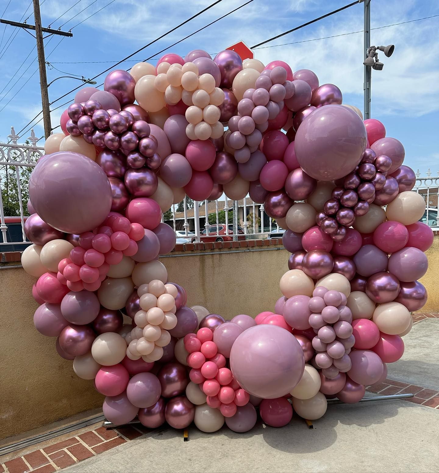 a wreath made of pink and purple balloons