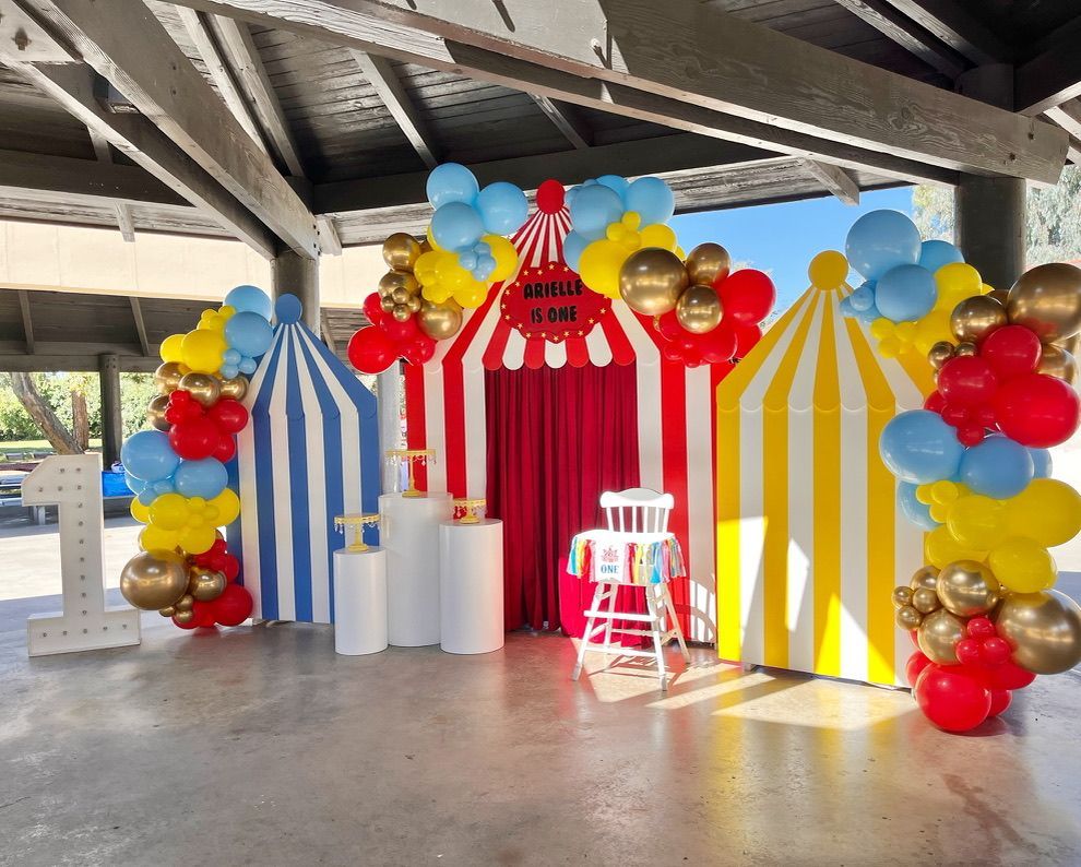a room decorated with balloons in the shape of a circus tent