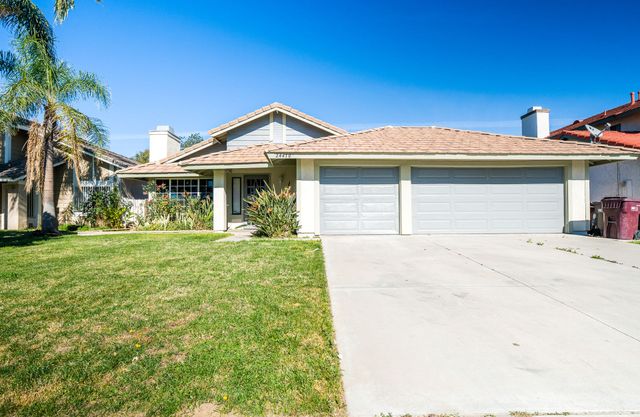 Discover this charming single-story residence in the desirable Rainbow Ridge neighborhood of Moreno Valley. This well-designed floor plan offers 3 bedrooms and 2 full bathrooms in approximately 1,248 sq ft of comfortable living space, set on a generous ~7,405 sq ft lot. A bright and open interior flows seamlessly from room to room, featuring a gourmet kitchen with granite countertops, stainless steel appliances, abundant cabinetry, and tile flooring throughout the main hall. The living and family rooms provide a welcoming atmosphere with a cozy fireplace — perfect for gatherings or relaxed everyday living. Large bedrooms with carpeted floors and ceiling fans enhance the comfort of this home, while central air conditioning ensures year-round climate control. The exterior impresses with fully landscaped front yard and a spacious backyard with concrete and paver surfaces, ideal for outdoor entertaining and a dog run. A rare 3-car attached garage offers plenty of parking and storage options. Located near schools, shopping, dining, and major freeways for convenient commuting, this property blends classic suburban living with great accessibility. Don’t miss this opportunity in a well-established Moreno Valley community — a must-see home!