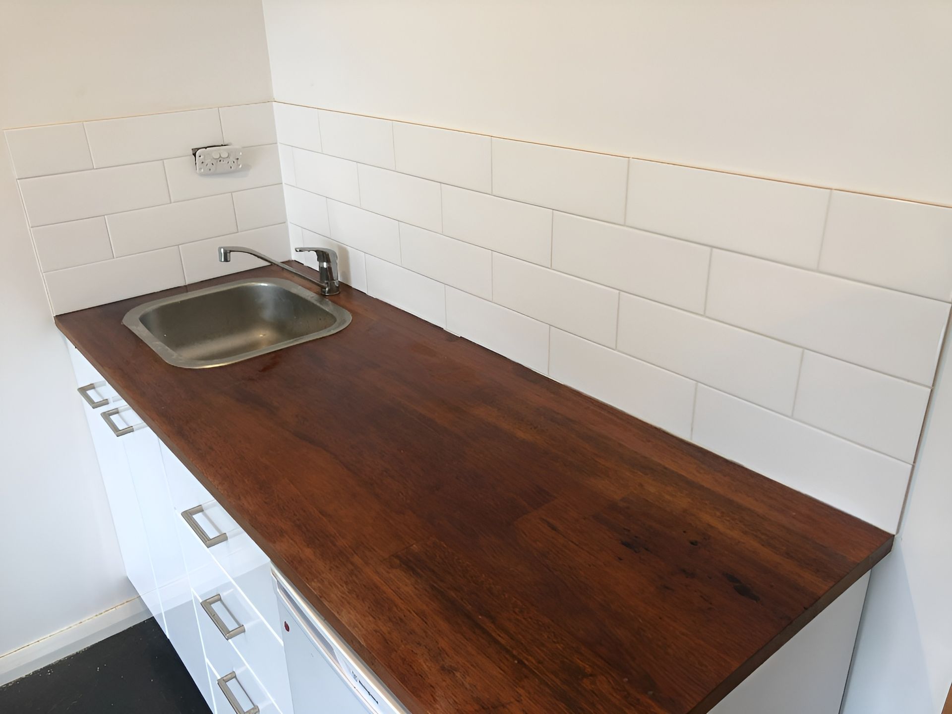 Small Kitchen Counter with A Stainless Sink — Midcoast Wall & Floor Tiling in Toormina, NSW