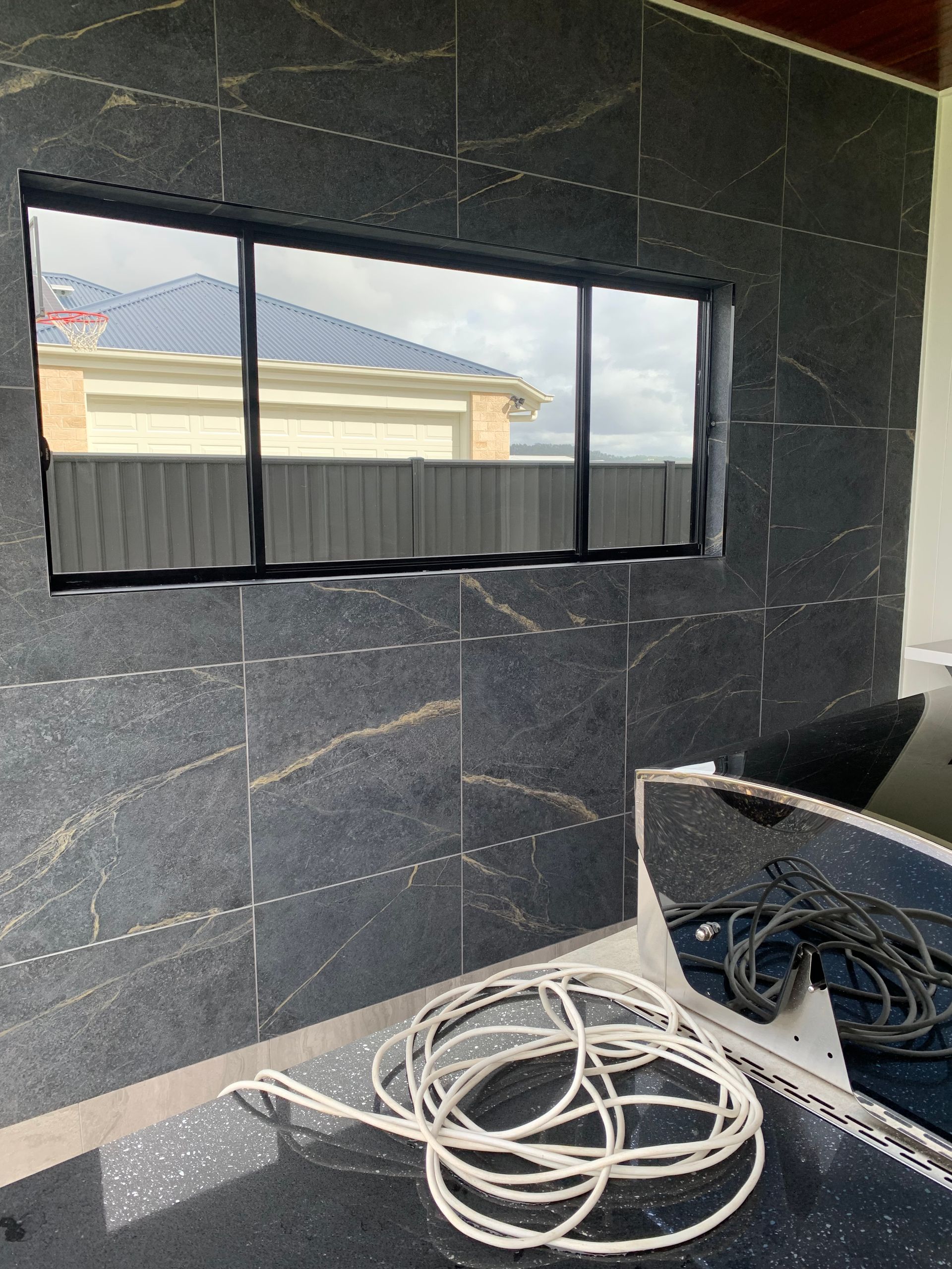 Interior Room with Dark Tiled Wall, Window — Midcoast Wall & Floor Tiling in Sapphire Beach, NSW