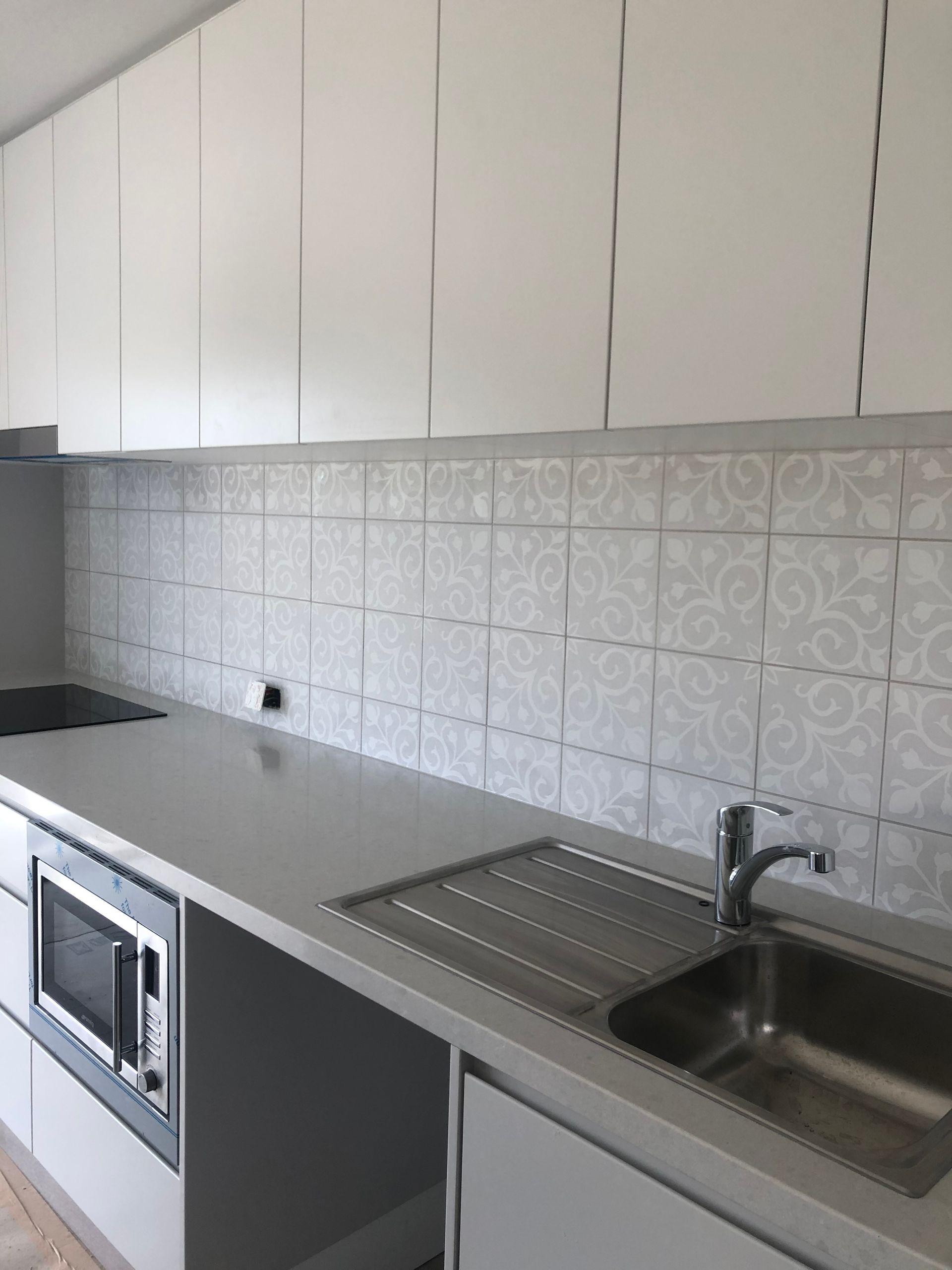 Modern Kitchen with White Cabinets, Grey Countertop — Midcoast Wall & Floor Tiling in Woolgoolga, NSW