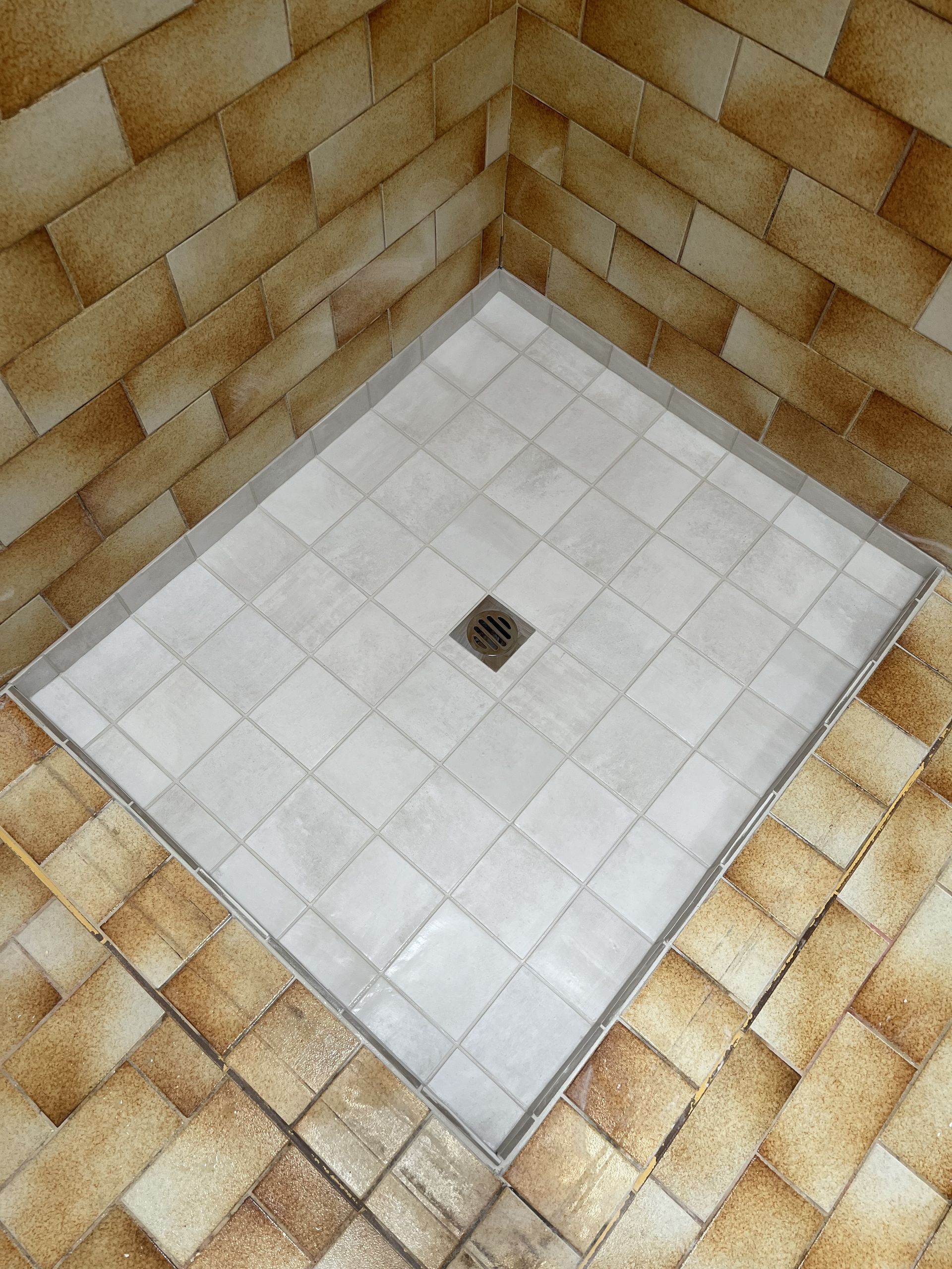 White Tiled Shower Floor with A Central Drain — Midcoast Wall & Floor Tiling in Woolgoolga, NSW