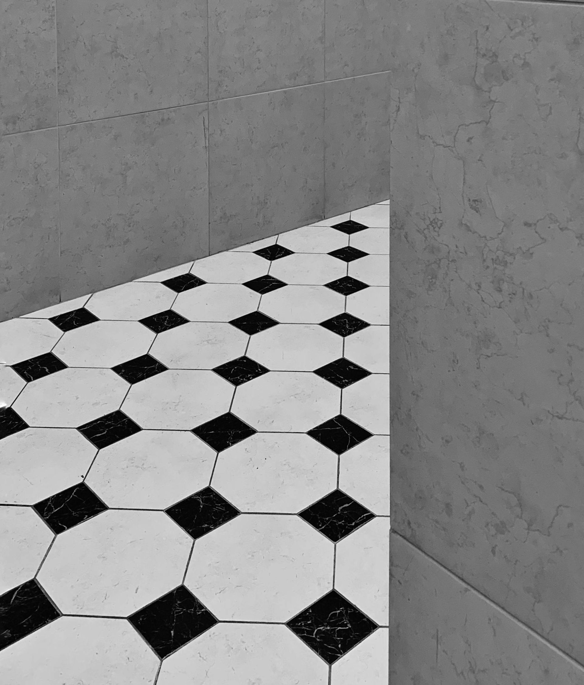 Black-And-White Tiled Floor in A Tiled Corner — Midcoast Wall & Floor Tiling in Toormina, NSW