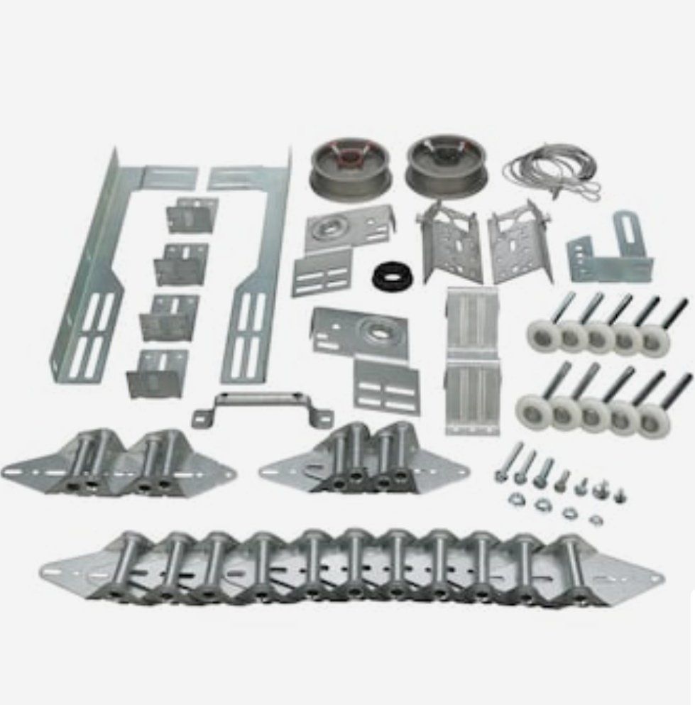 Assorted metal hardware and mounting brackets with wheels, screws, and fasteners on a white background