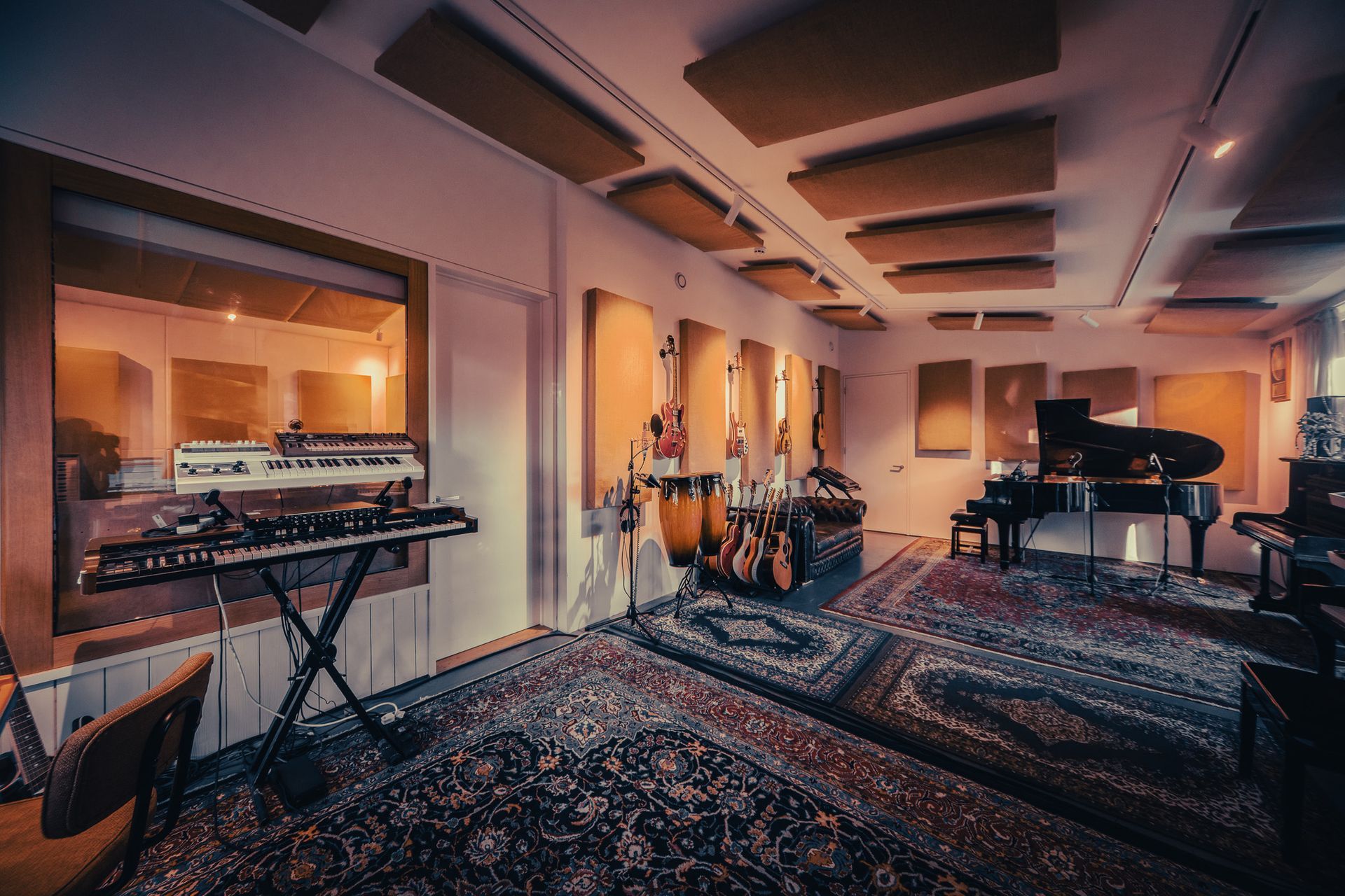 a large room with a piano and drums in it
