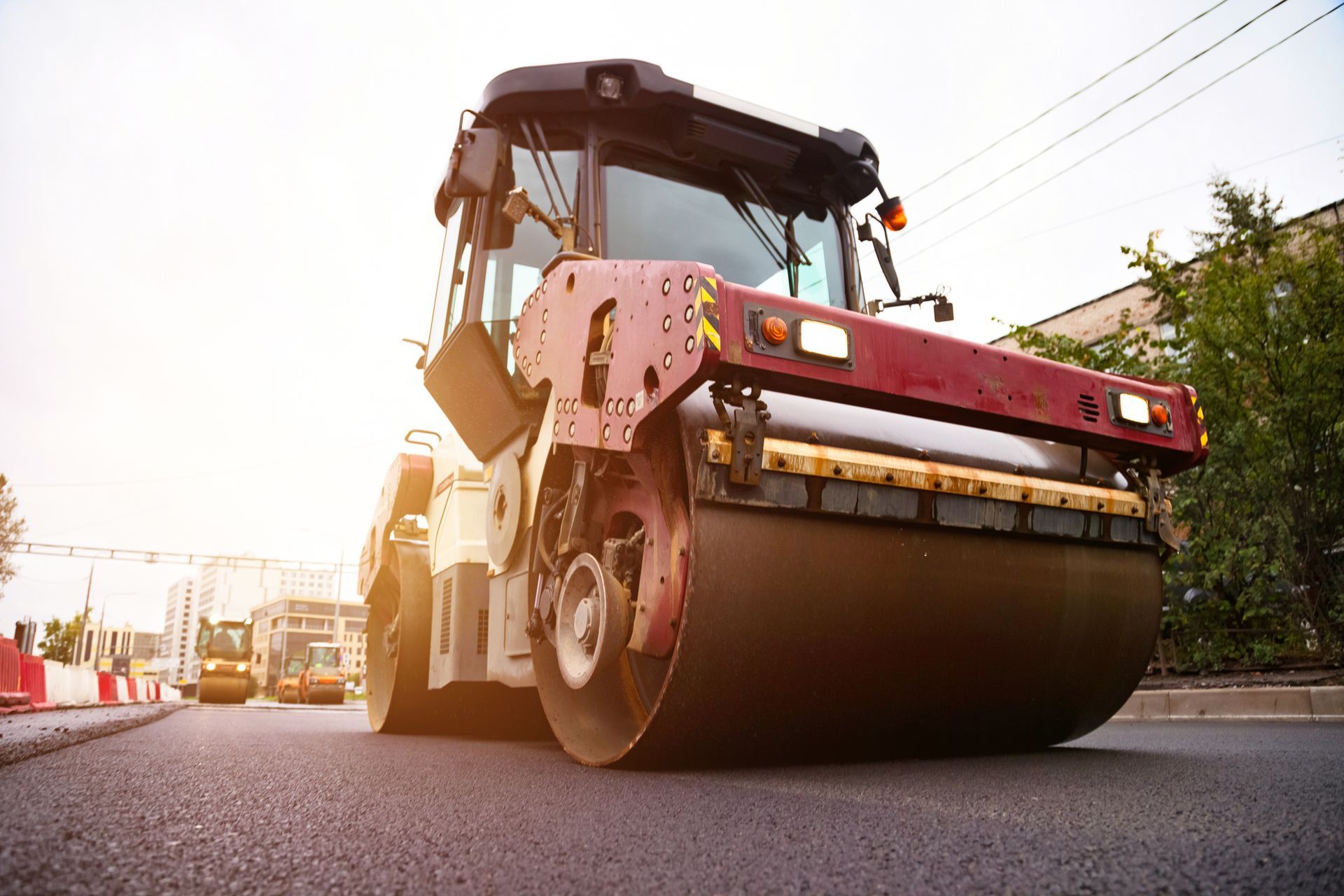 Heavy machinery is used to lay asphalt concrete. Heavy machinery is used to lay asphalt concrete.