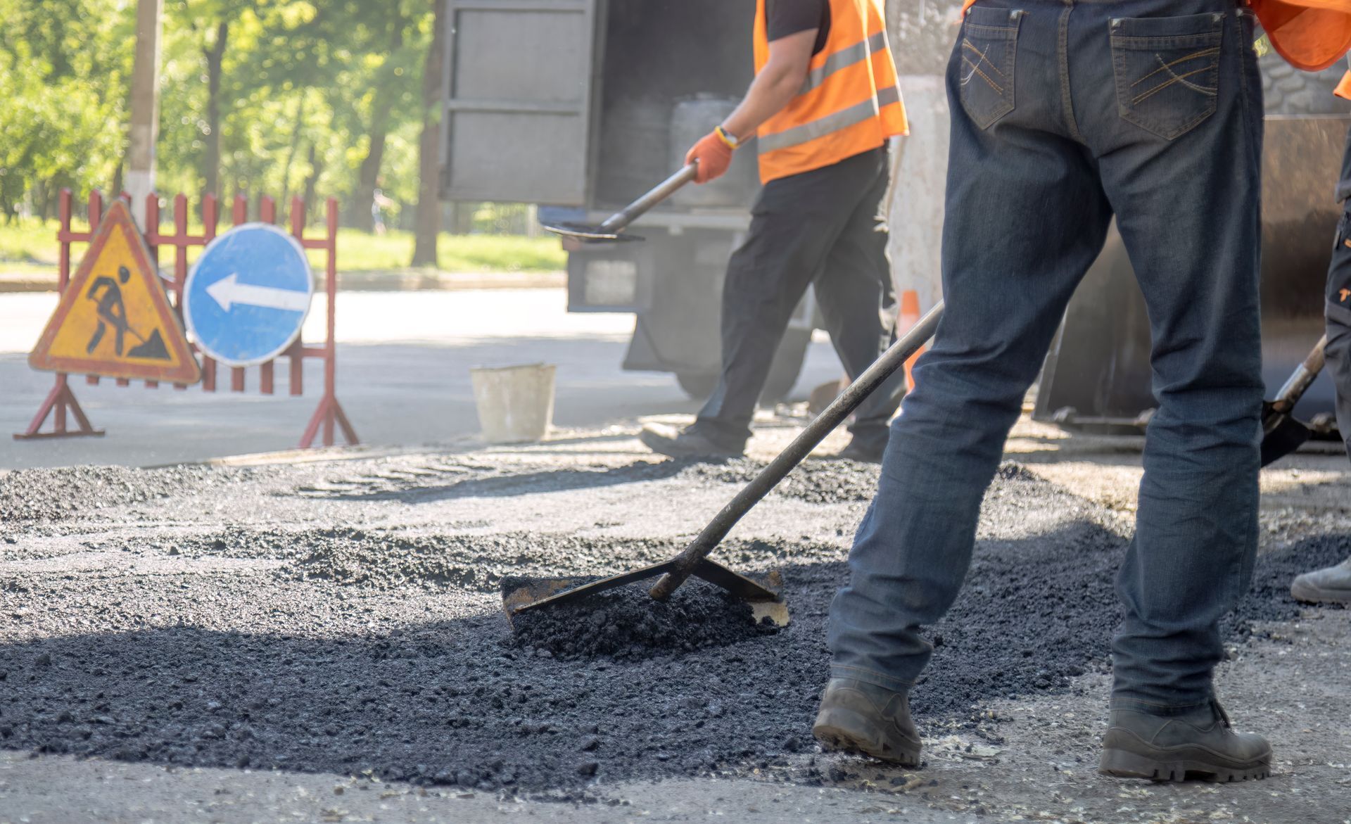 Commercial paving contractor crew installing fresh asphalt on roadway construction project. Commercial paving contractor crew installing fresh asphalt on roadway construction project.
