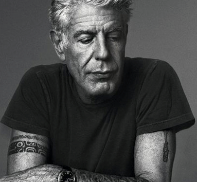 A man with a tattoo on his arm is wearing a watch.