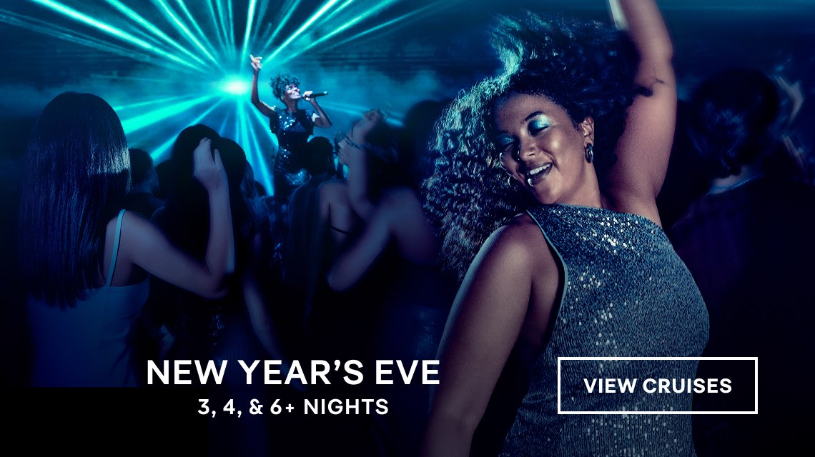 Crowd dancing under blue lights at a New Year’s Eve cruise party, with “View Cruises” text.