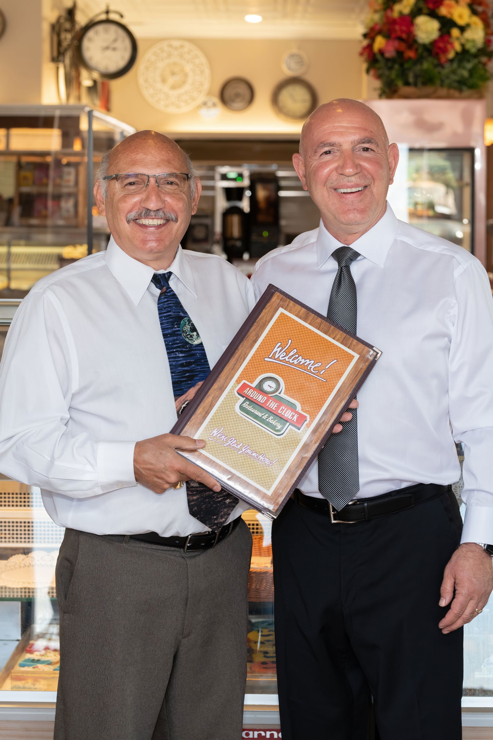 Owners holding restaurant menu