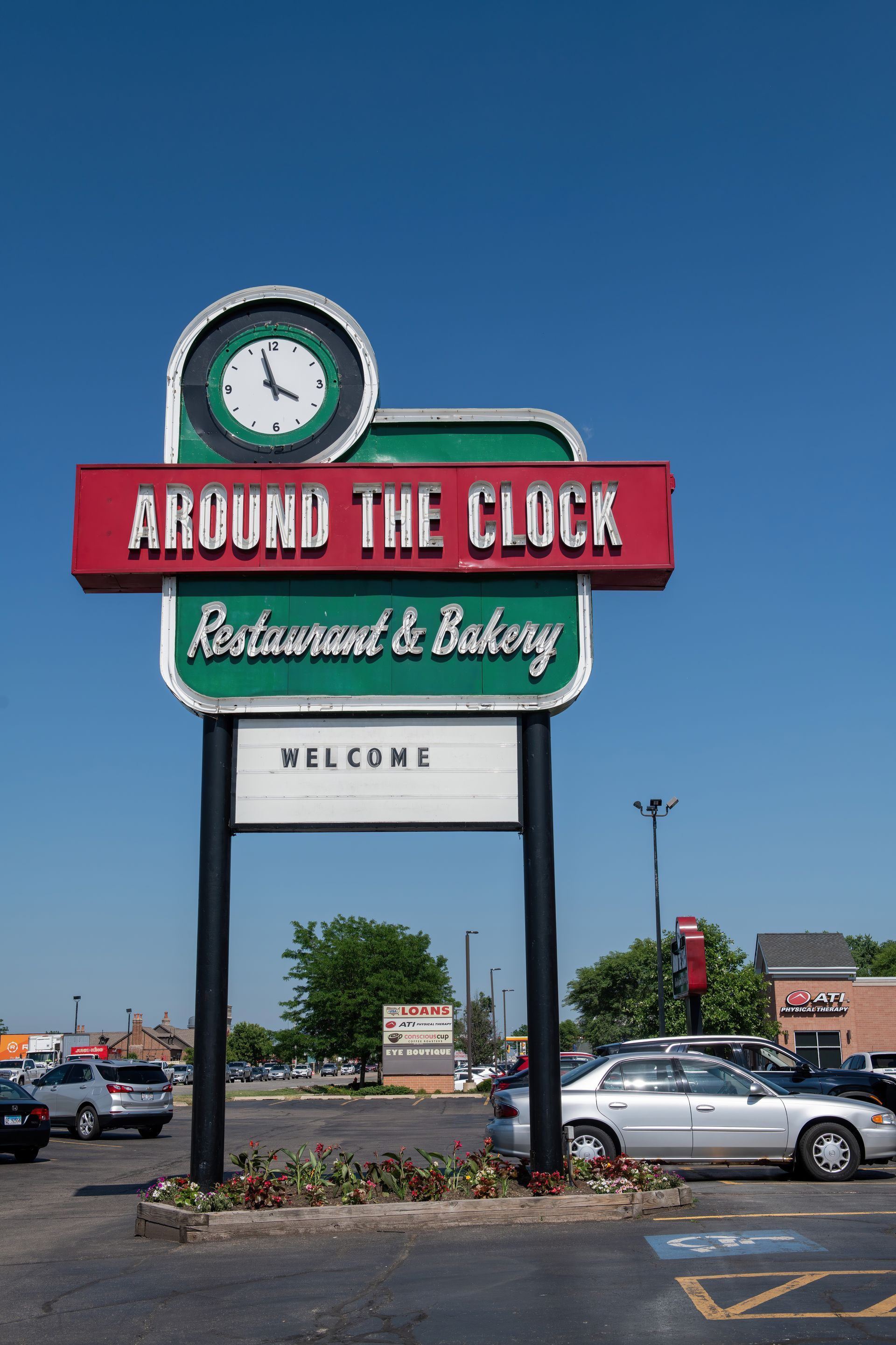 A sign for around the clock restaurant and bakery