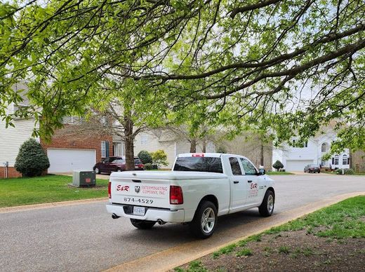 A White Truck Is Parked on The Side of The Road in A Residential Neighborhood — Newport News, VA — E & R Exterminating Company, Inc. A White Truck Is Parked on The Side of The Road in A Residential Neighborhood — Newport News, VA — E & R Exterminating Company, Inc.