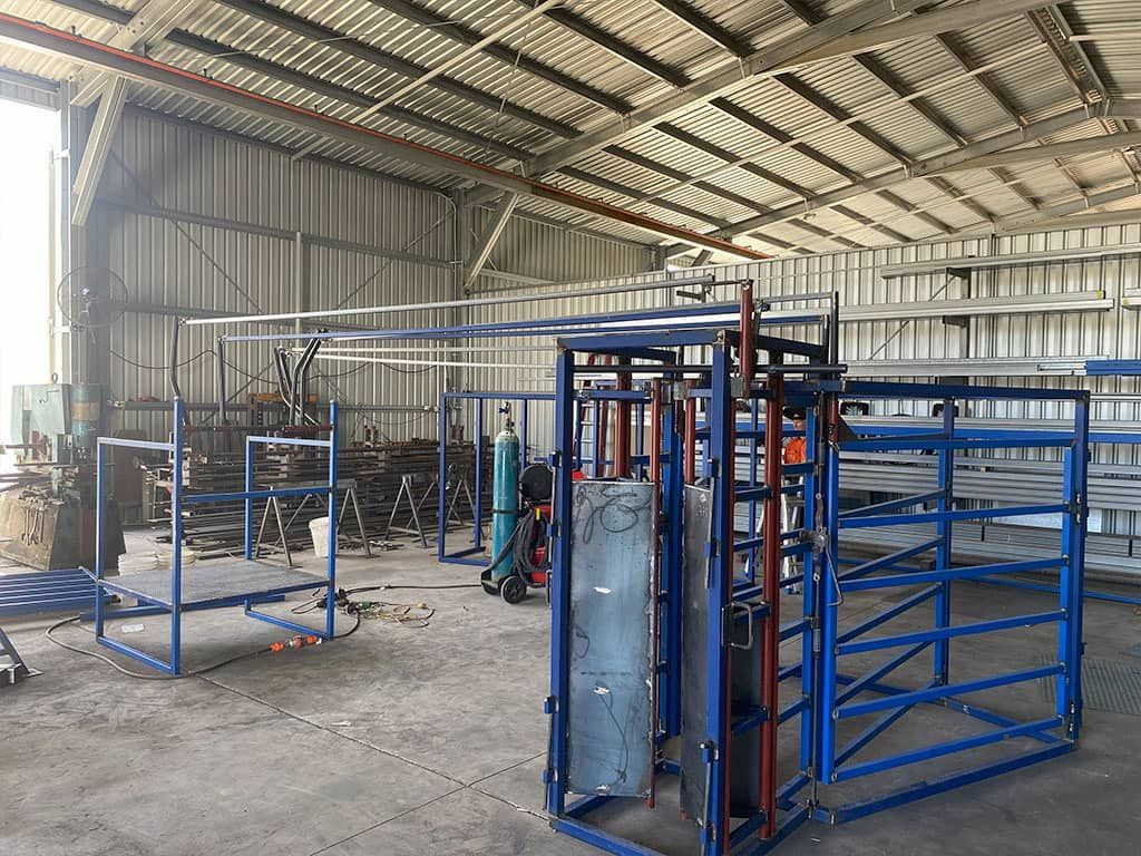 A Large Warehouse Filled With Lots Of Blue Metal Structures — Quality Fabrications & Welding Pty Ltd In Bohle, QLD