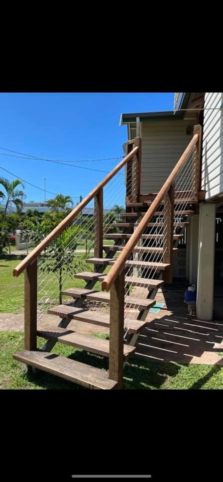A Set Of Wooden Stairs Leading Up To A House — Quality Fabrications & Welding Pty Ltd In Bohle, QLD
