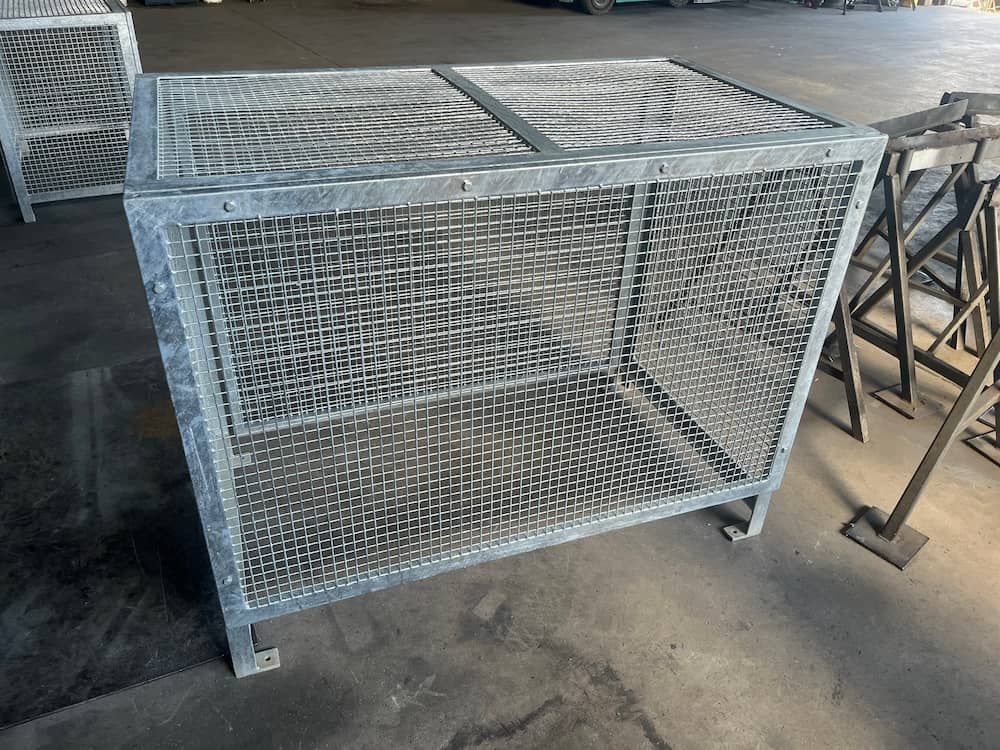 A Metal Cage Is Sitting On The Ground In A Warehouse — Quality Fabrications & Welding Pty Ltd In Bohle, QLD