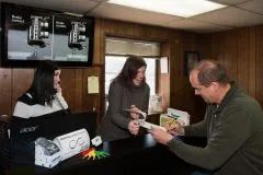 Checking phone on front desk  | Joey's Truck & Auto Repair