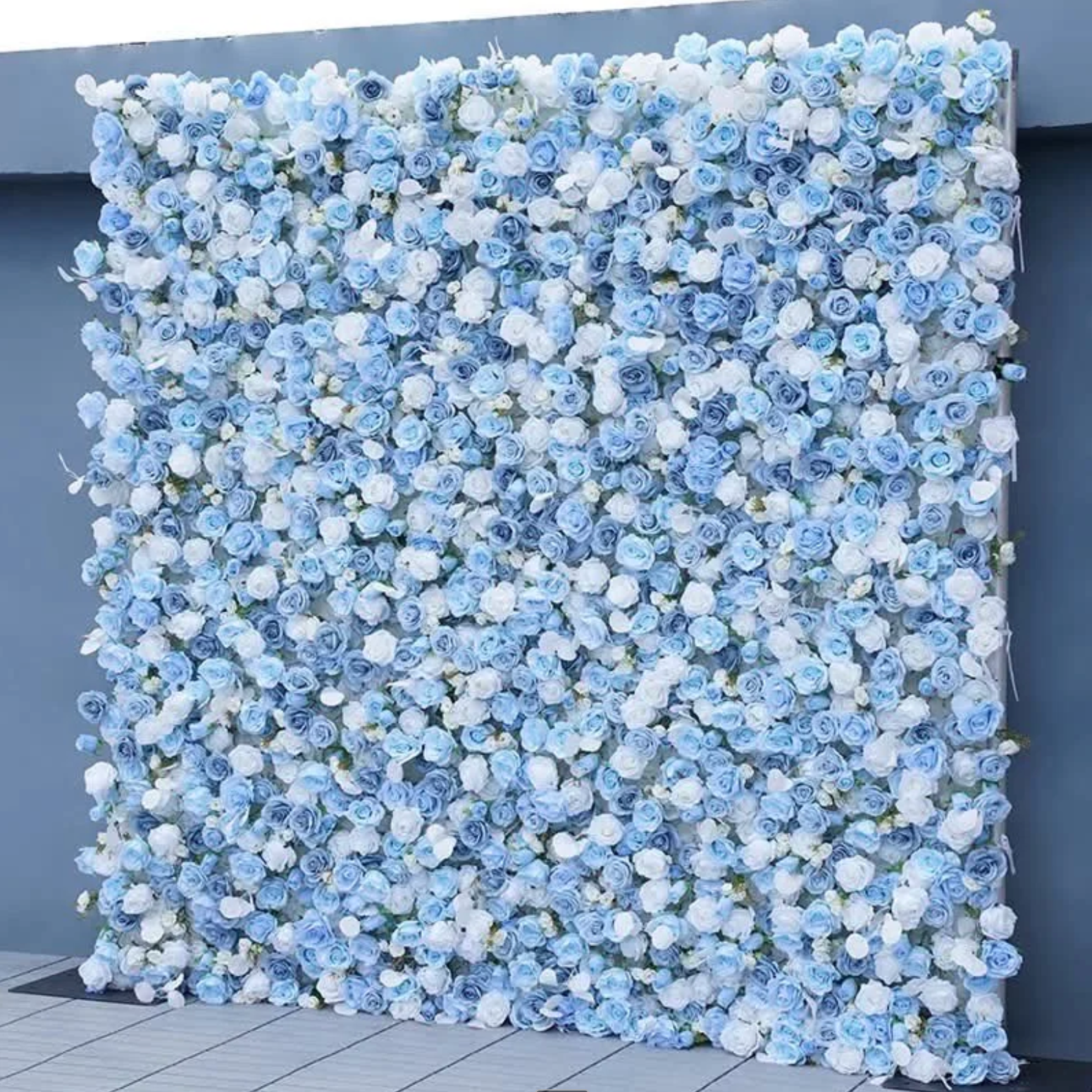 A square wall covered in densely packed light blue and white flowers
