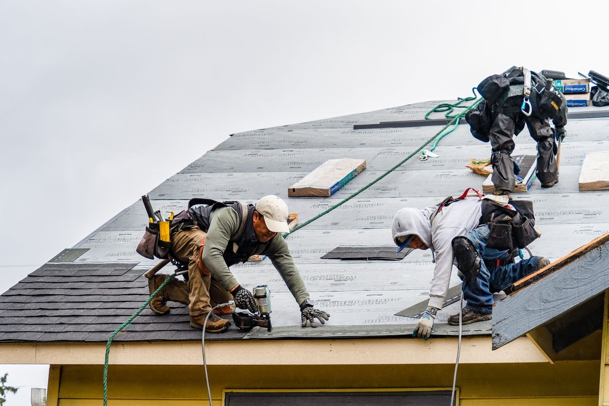 A man is using a drill to install a metal roof.