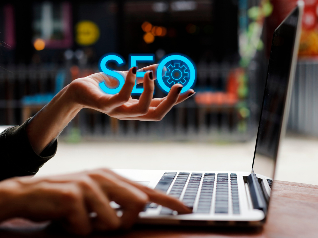 Woman using laptop, holding glowing 