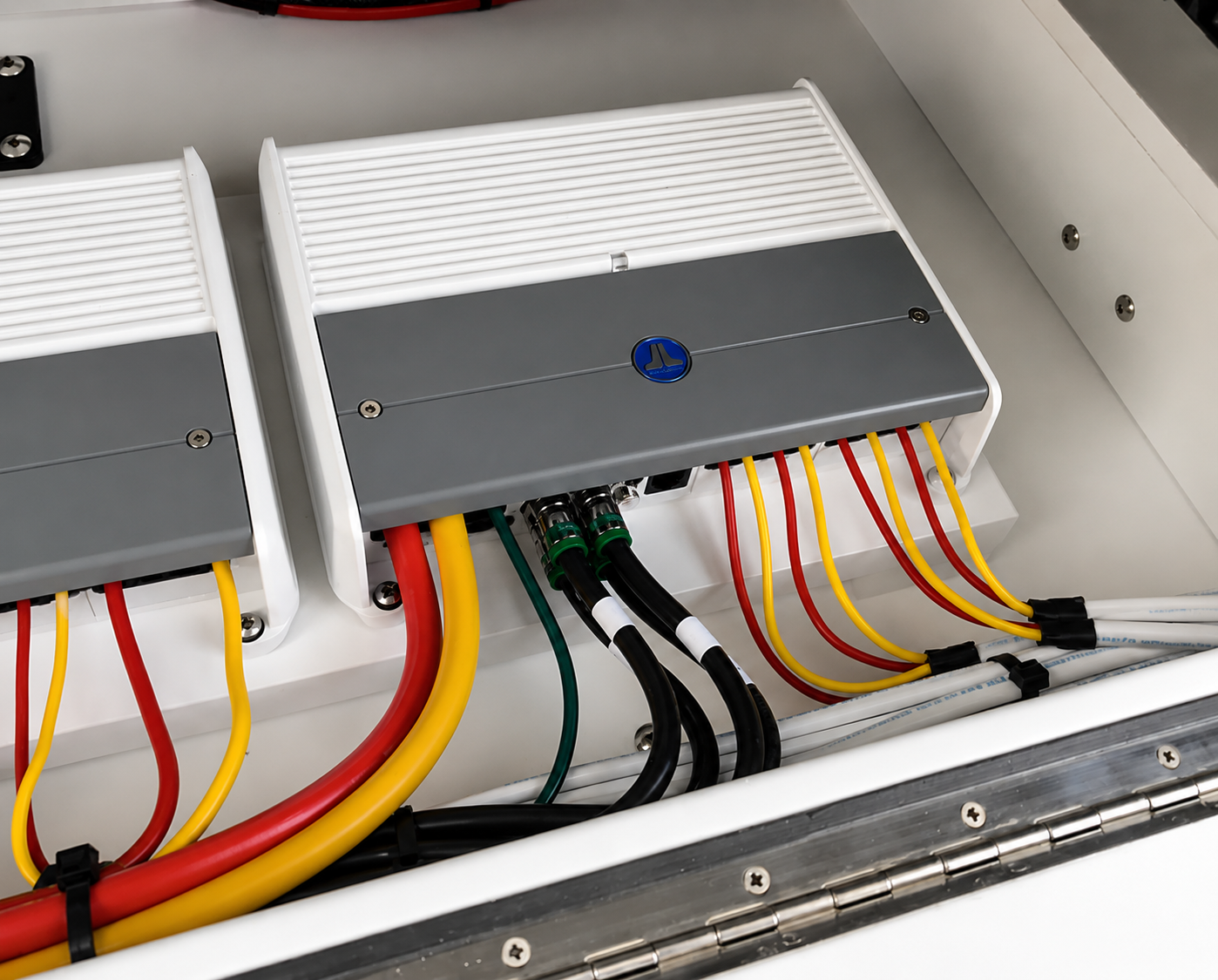 Electrical control boxes with multicolored wires inside an open compartment