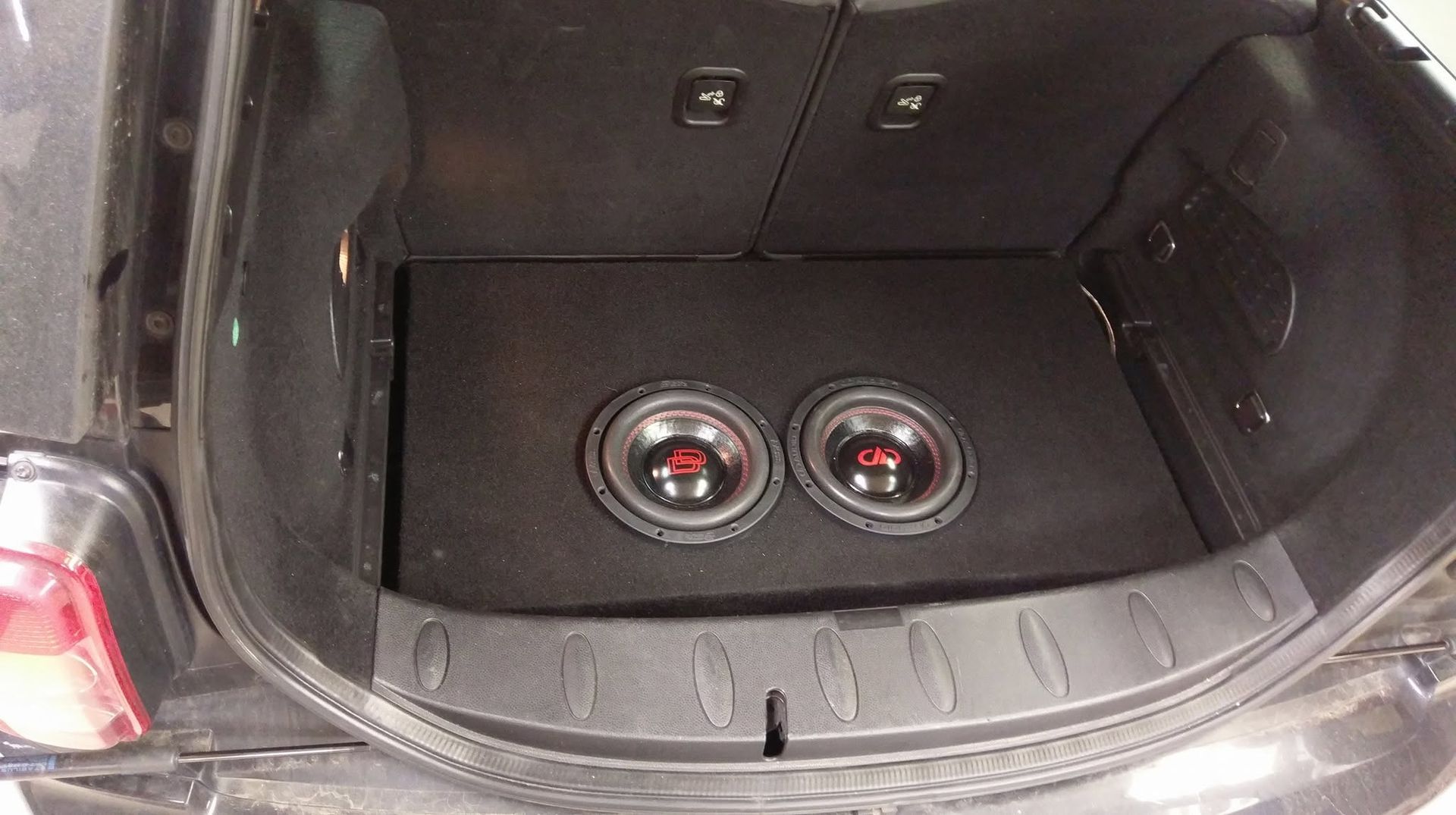 Car trunk with two subwoofers installed in the cargo floor