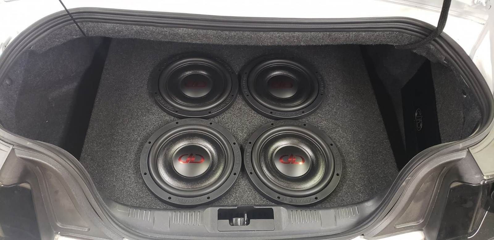 Car trunk with a custom speaker/subwoofer audio system in black enclosure