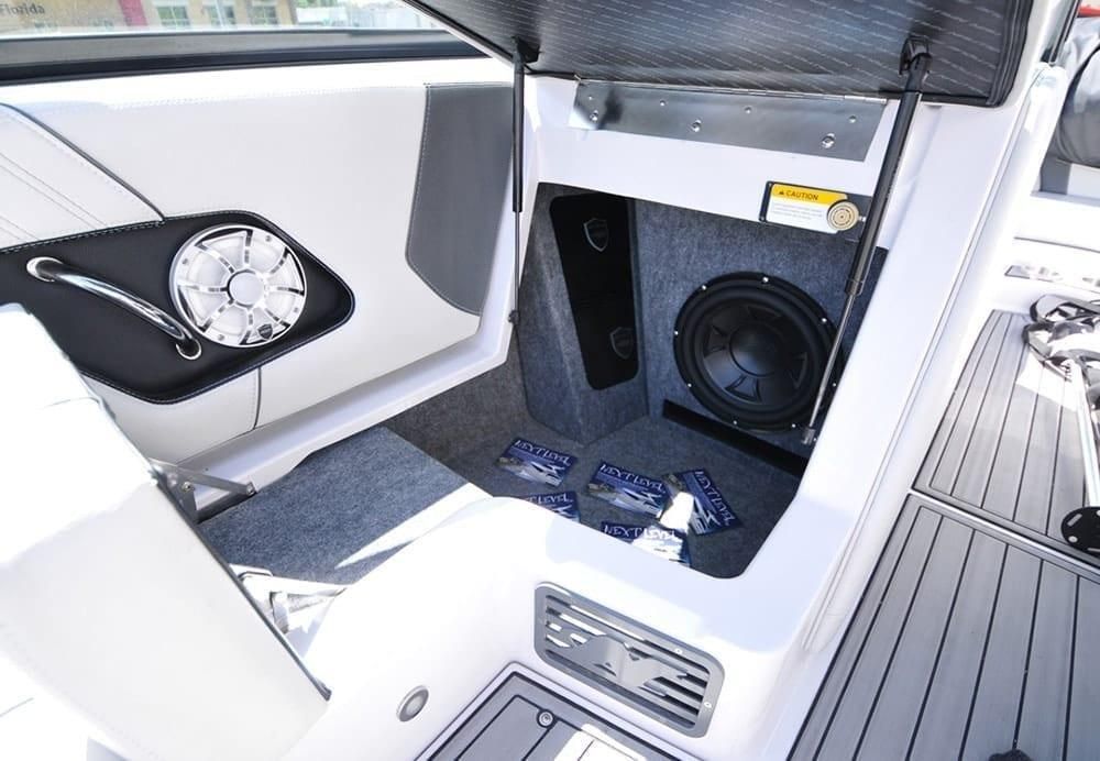 Boat cabin with a built-in subwoofer, speakers, and white seating