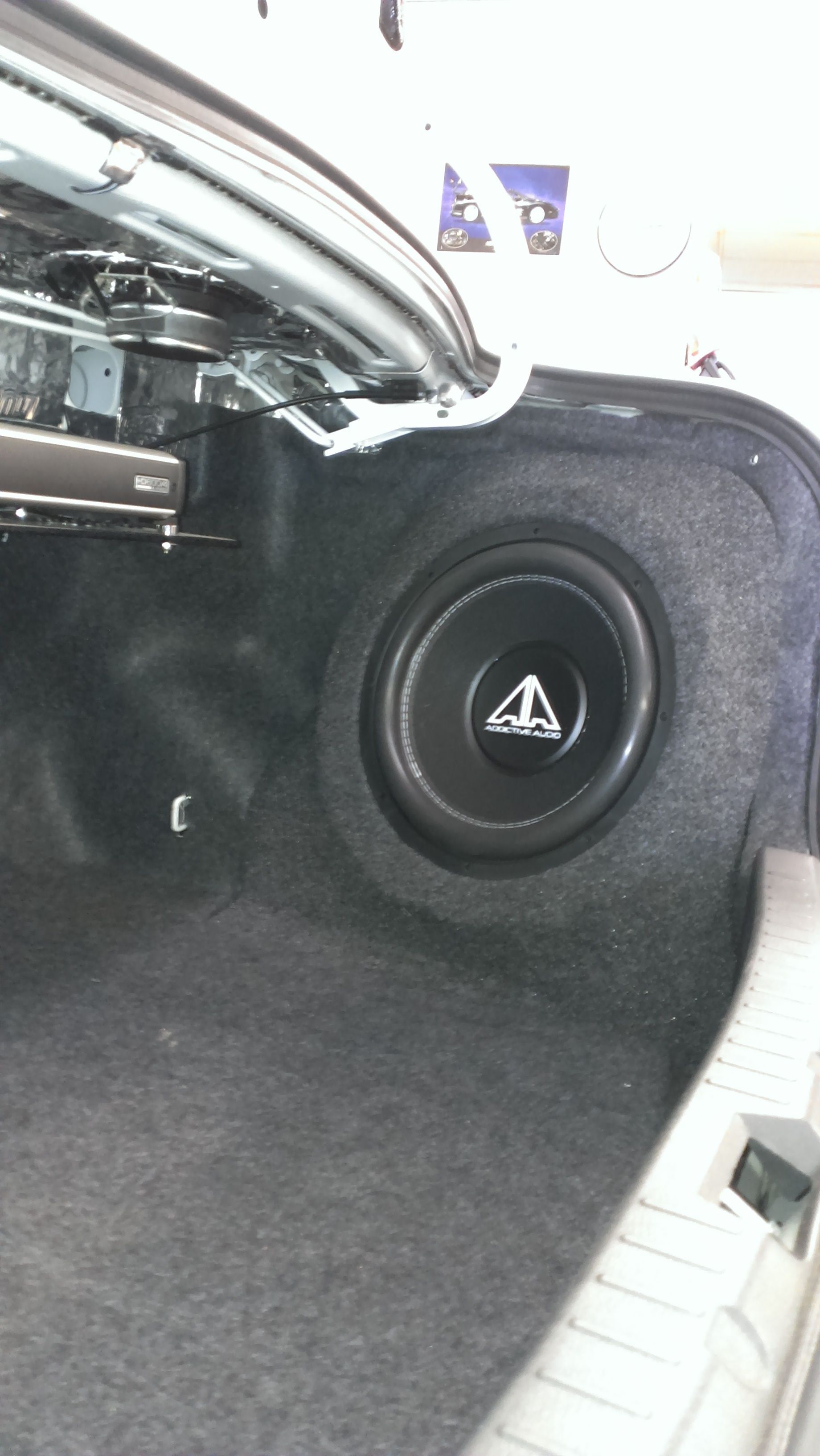 Open trunk with a spare tire, black interior and silver exterior