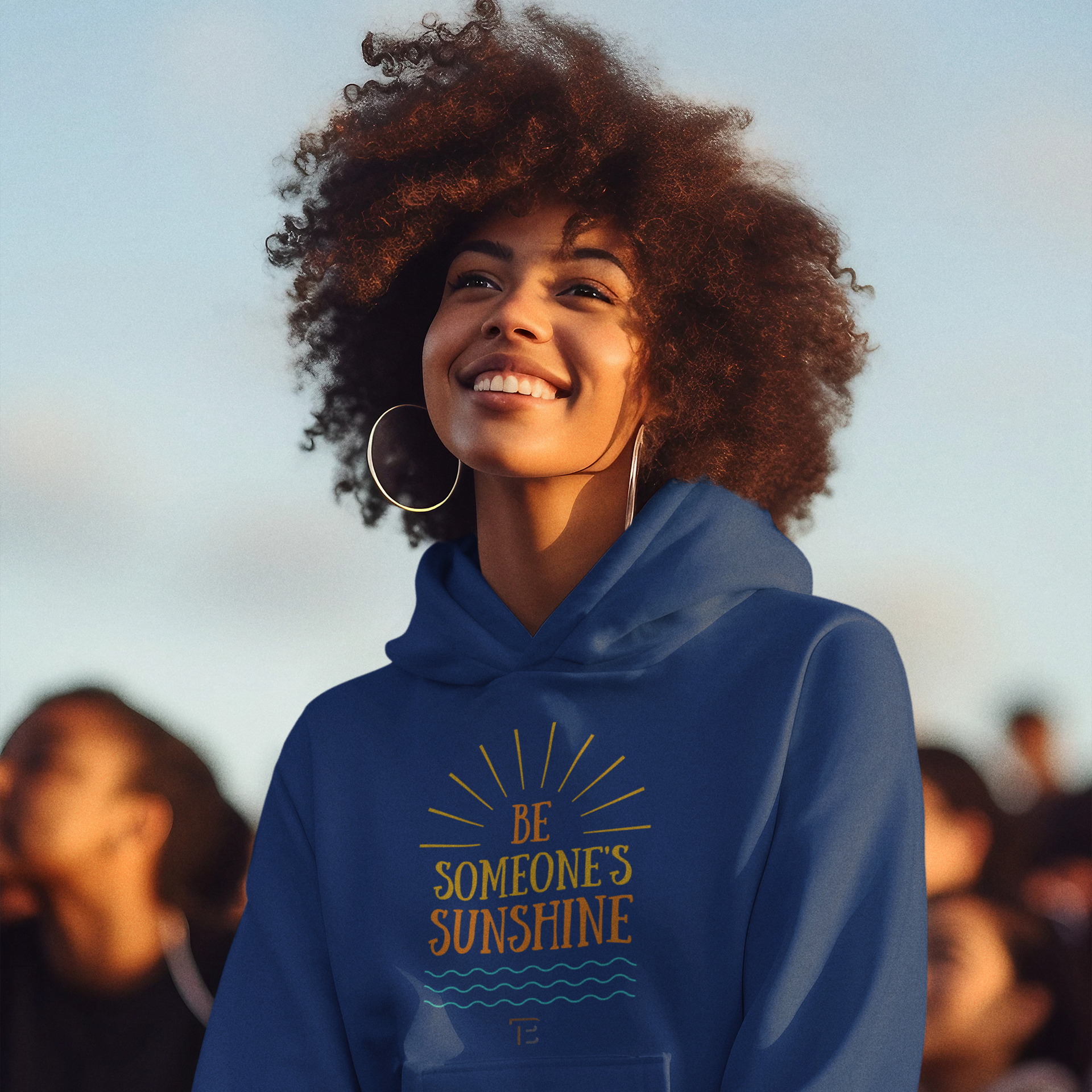 A woman wearing a blue hoodie that says be someone 's sunshine