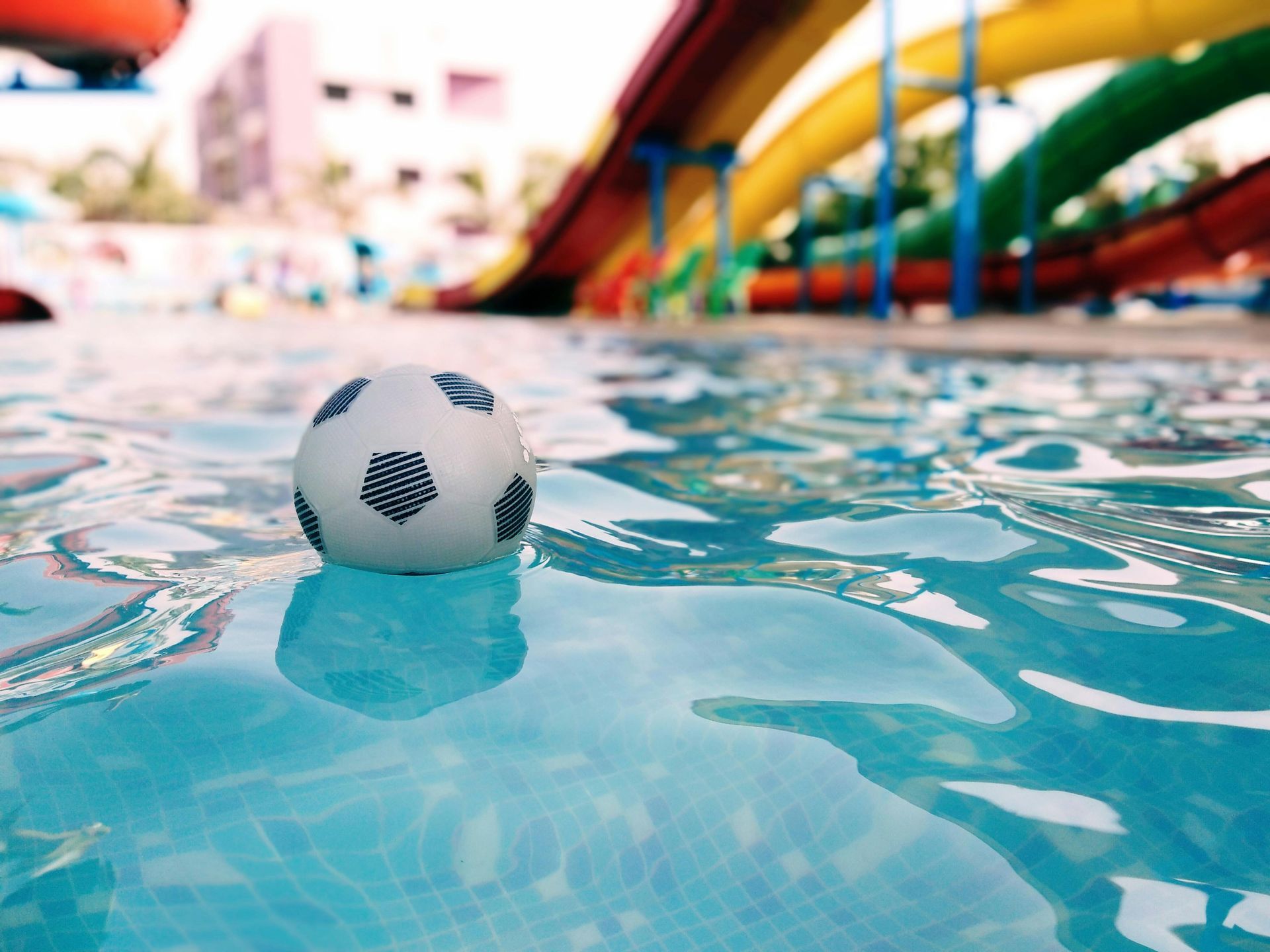 A woman 's legs are sticking out of a swimming pool.