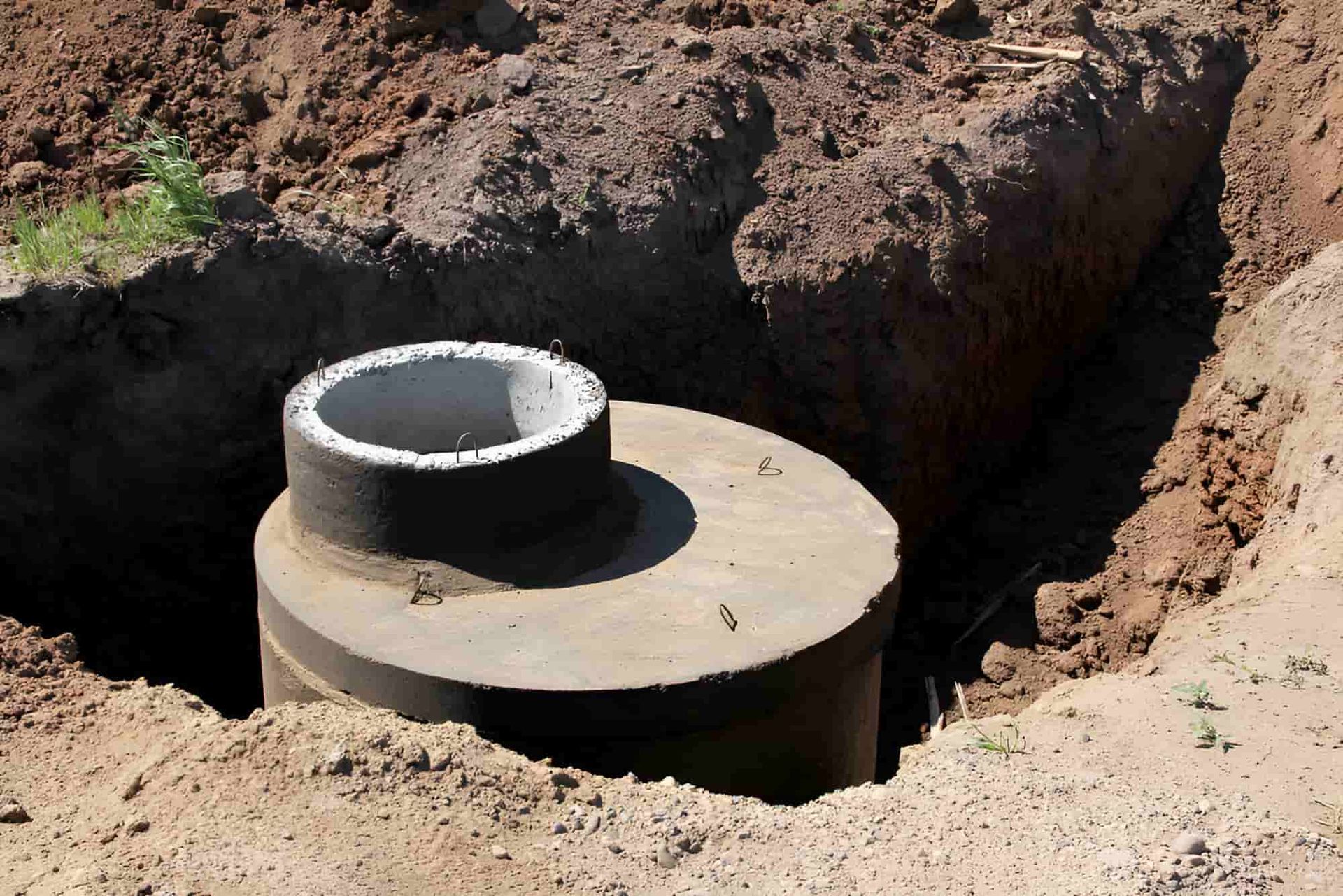 A Concrete Pipe Is Sitting In A Hole In The Ground — Gillen Plumbing In Ciccone, NT